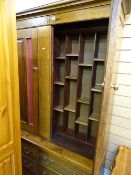 Oak two door bookcase cupboard with multi compartmented shelves over six drawer base
