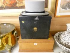 Moss Bros top hat in box and an oak lidded storage casket