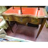 Reproduction mahogany serpentine front desk with gilt tooled red leather top
