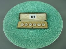 Commonwealth commemorative plate and a cased set of yellow metal and mother of pearl buttons