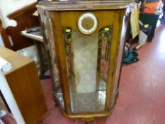 Small china cabinet with clock to the front