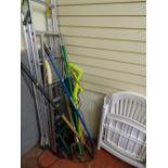 Two aluminium stepladders and a parcel of long handled garden tools, Ryobi strimmer etc E/T