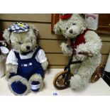 Two millennium collectable teddy bears, one on a bicycle