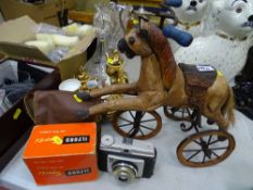 Model wooden horse on a bicycle and a small parcel of vintage cameras