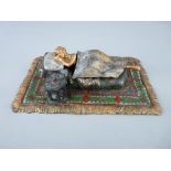 Cold bronze Bergman figurine of a reclining nude lady on an oblong rug