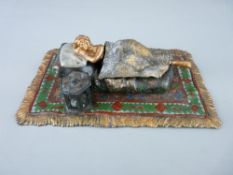 Cold bronze Bergman figurine of a reclining nude lady on an oblong rug