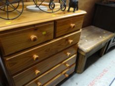 A modern honey pine chest of drawers, two short above four long together with a chunky pine coffee