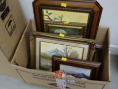 A box of various framed pictures