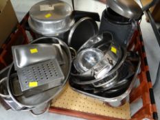 A crate of mainly stainless steel cookware, sieves, pressure cooker etc
