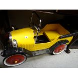 A vintage child's metal pedal car