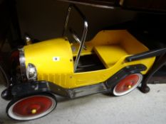 A vintage child's metal pedal car