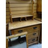 A light oak Arts & Crafts-style three-drawer dressing table