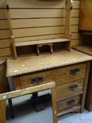 A light oak Arts & Crafts-style three-drawer dressing table