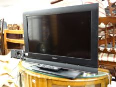 A Sony flatscreen 26-inch television together with a Bush sound bar E/T