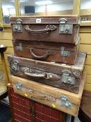 Four vintage brown leather suitcases