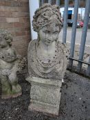 A composite stone head & shoulders of a classical female on a short plinth (outside)
