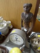 A modern London Clock Company dome top mantel clock together with a carved tribal figure