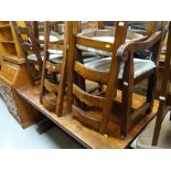 A modern chunky hardwood refectory dining table together with six ladder backed matching chairs with