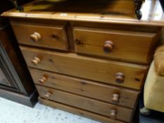 A honey pine chest of drawers, two short above three long