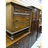 A vintage oak linen fold-style bedroom suite by Lock of London comprising two-door wardrobe, three-