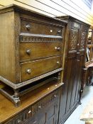 A vintage oak linen fold-style bedroom suite by Lock of London comprising two-door wardrobe, three-
