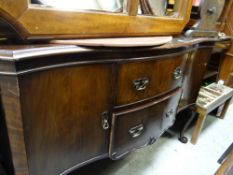 A vintage mahogany serpentine sideboard, two drawers flanked by two cupboards over cabriole