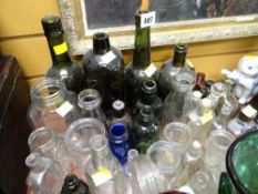 A tray of various clear & coloured glass bottles