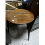 An antique oak cricket style table