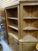 A modern pine unit three shelves with a cupboard base together with a similar pine standing corner
