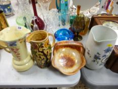 Three decorative pottery jugs and an Italian ceramic bread basket