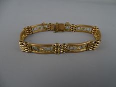 Nine carat gold four bar and scrolled link bracelet with safety chain, 16.9 grms