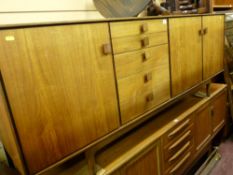 Mid Century teak sideboard with three cupboard doors and five central drawers