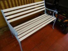 White painted garden bench with blue cast ends