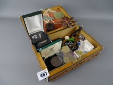 Vintage carved wooden box containing various collectable items including a jade necklace, coinage