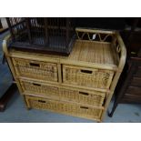 A wicker chest of drawers, two short above two long with a gallery top