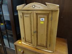 A miniature pine two-door corner cupboard