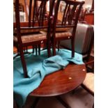 A reproduction mahogany circular extending dining table together with a set of six (2+4) matching