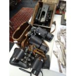 Four pairs of binoculars together with a vintage cased bubble sextant