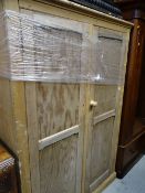 A vintage stripped pine two-door school-room shelved cupboard, 185 x 123 x 43cms