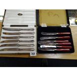 A case of hallmarked silver-handled cake knives together with a cased set of EPNS butter knives