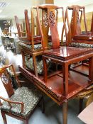 An Oriental hardwood carved extending dining table & eight (2+6) matching loose cushion chairs,