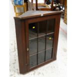 An antique oak and glazed hanging corner cupboard