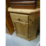 A pine standing corner cupboard, single drawer above a cupboard base