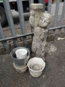 A concrete cherub with baskets & flower pots etc (outside)