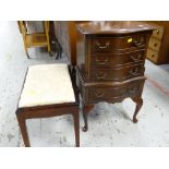 A neat reproduction mahogany four-drawer bow front chest of raised feet together with a dark wood