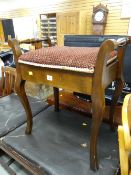 A vintage mahogany piano stool