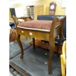 A vintage mahogany piano stool