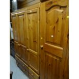 A honey pine four-door wardrobe