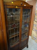 A good vintage dark oak coloured glass & leaded two-door bookcase, 173 x 89 x 30cms