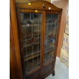 A good vintage dark oak coloured glass & leaded two-door bookcase, 173 x 89 x 30cms